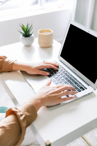 Woman Typing on Laptop