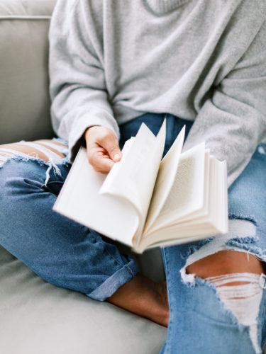 woman flipping pages in book