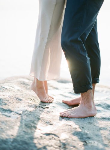 couple with their feet in the sand