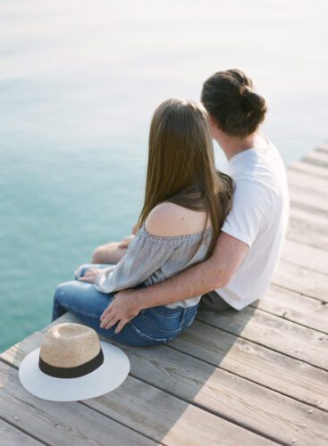 Couple sitting on pier