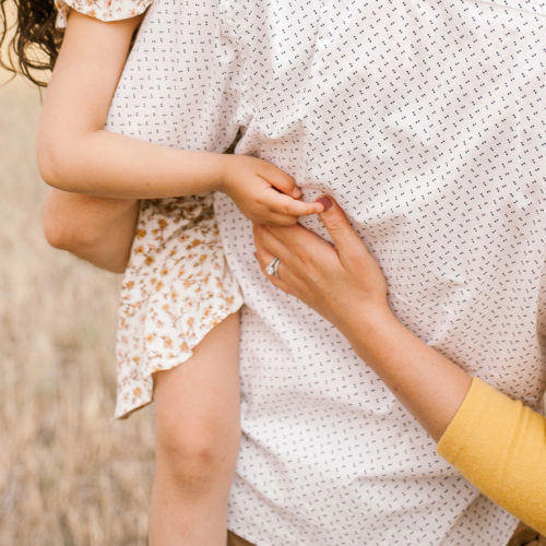 children hugging father