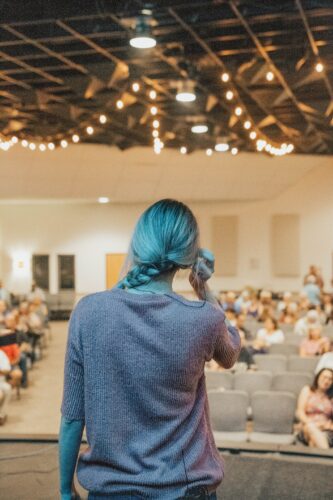 Woman on stage in front of a crowd