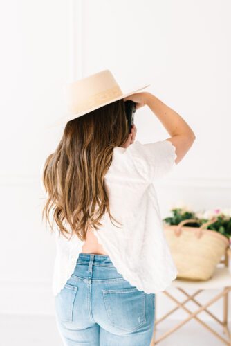 back of woman wearing sun hat