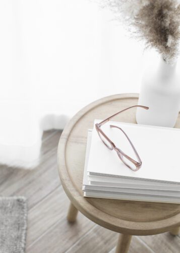 table with glasses on top of books