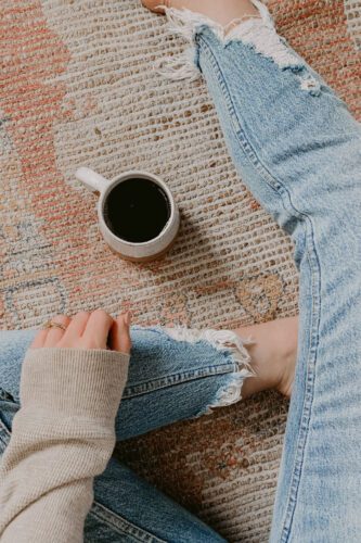 woman sitting on floor with coffee mug