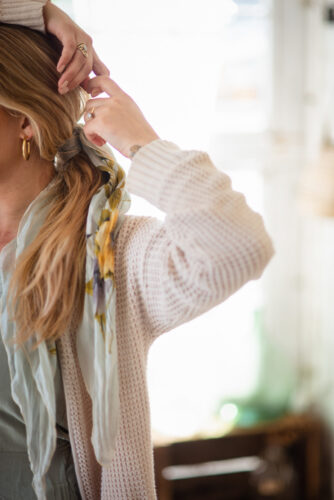 woman pulling back her hair