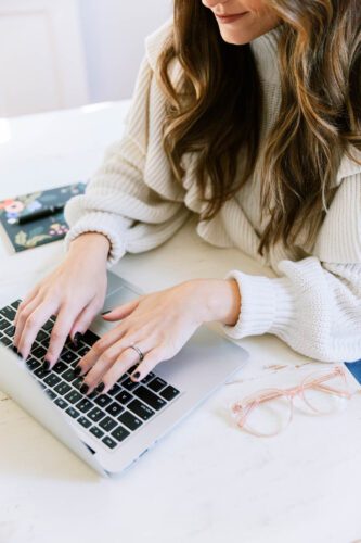 woman typing on her laptop