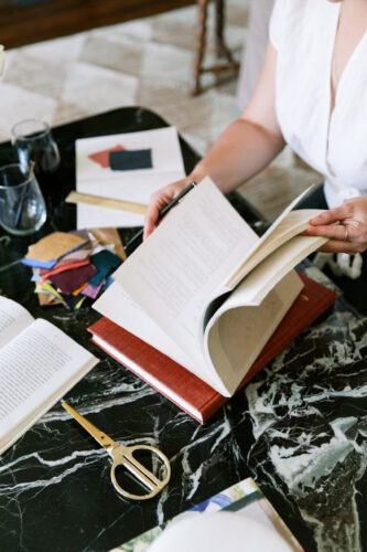 woman looking through pages in a book